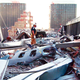 A worker surveys the debris from the collapse of the World Trade Center. A piece of the fuselage from United Flight 175 lies in the foreground.